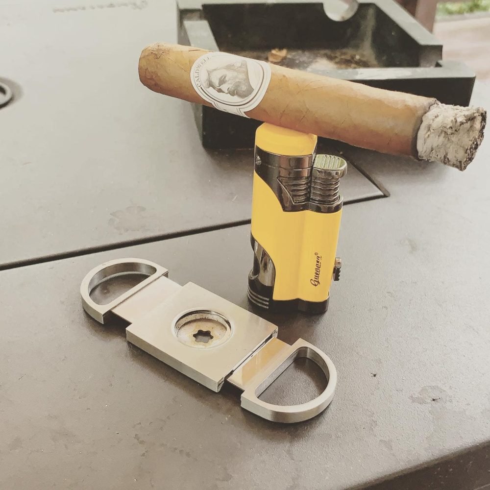 cigardays_cigarbalancedontopofalighter